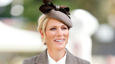 Image of Zara Tindall smiling at 2026 British Champions Day, wearing brown fascinator and with blonde hair in an updo