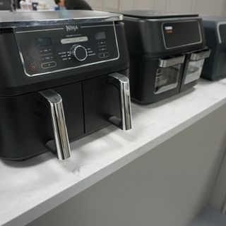Image of Ninja and Tower air fryers side by side on countertop