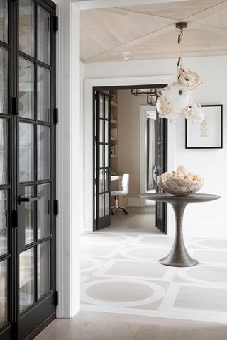 Hanging glass and rope light, black framed glass doors, wooden ceiling