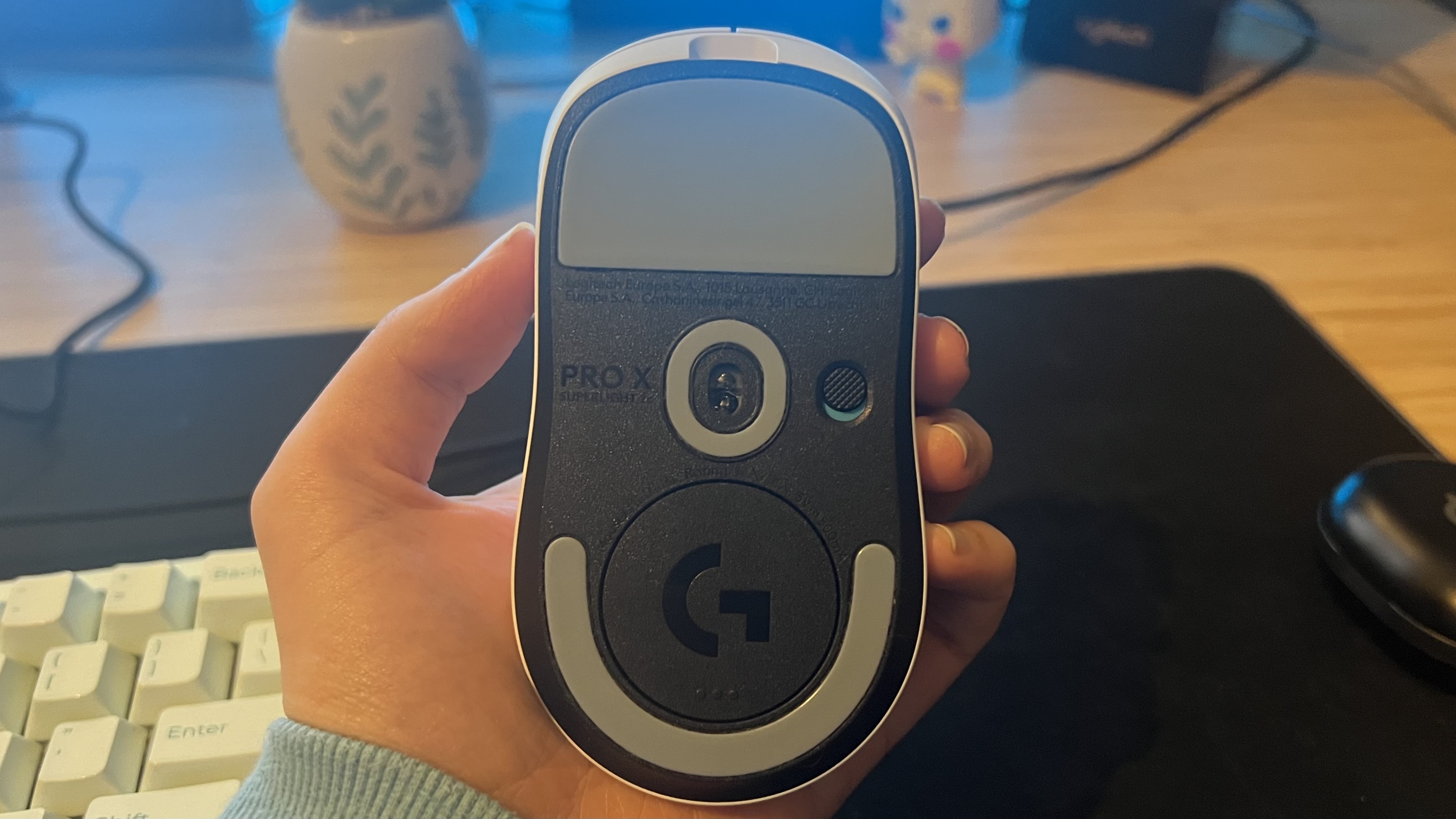 Underside of Logitech G Pro X Superlight 2c gaming mouse showing sensor and power button