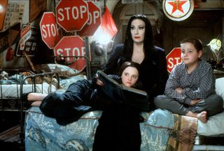 Christina Ricci, Anjelica Huston, and Jimmy Workman as Wednesday Addams, Morticia Addams, and Pugsley in The Addams Family