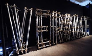 Versace written using metal construction bars