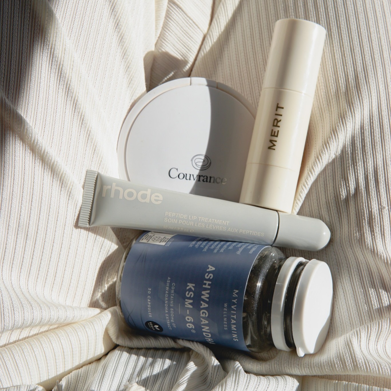 Photo of skincare products on a bed
