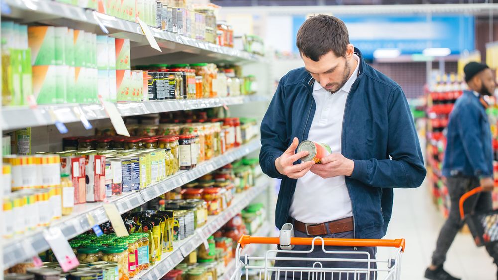 Man examines food label