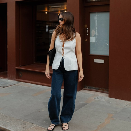 Kim in barrel-leg jeans and toe-strap sandals