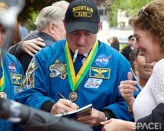 Mark and Scott Kelly humored a long line of autograph seekers after their West Orange town hall event on May 19, 2016.