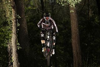 Sabrina Jonnier, of Hyères, France, rides through woods near her home in the lead up to the 2010 World Cup season