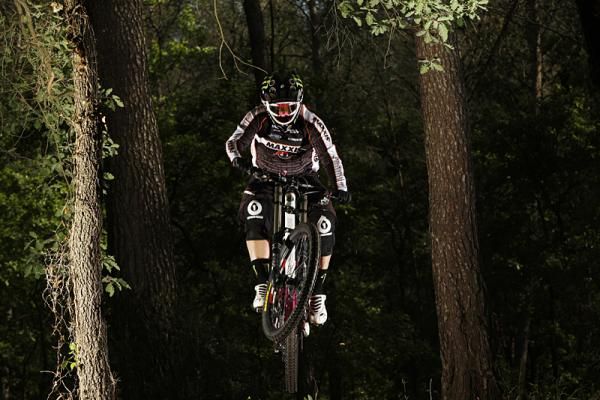 Sabrina Jonnier, of Hy&egrave;res, France, rides through woods near her home in the lead up to the 2010 World Cup season