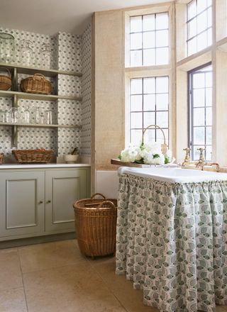 cream and green wallpaper in a country kitchen with matching sink skirt