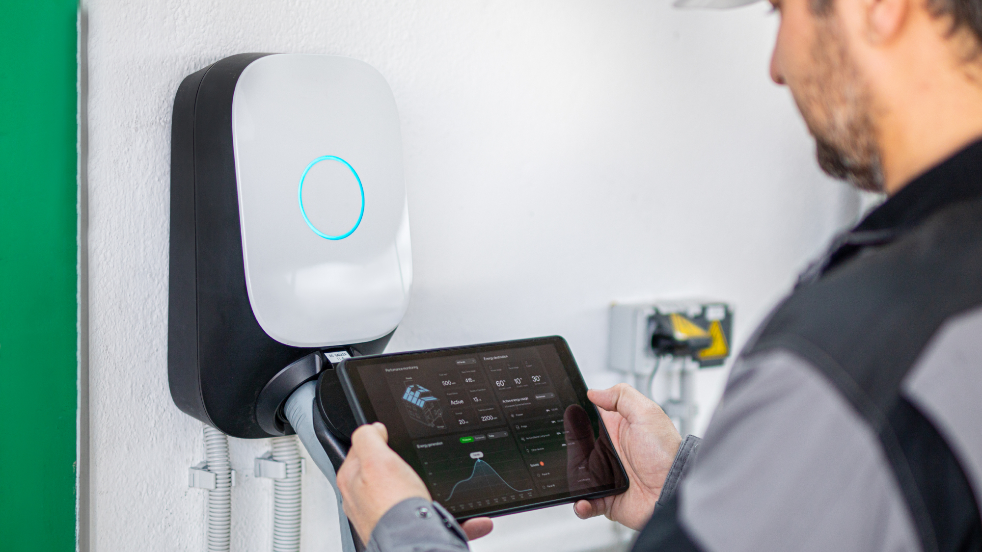 male checking EV charger installation