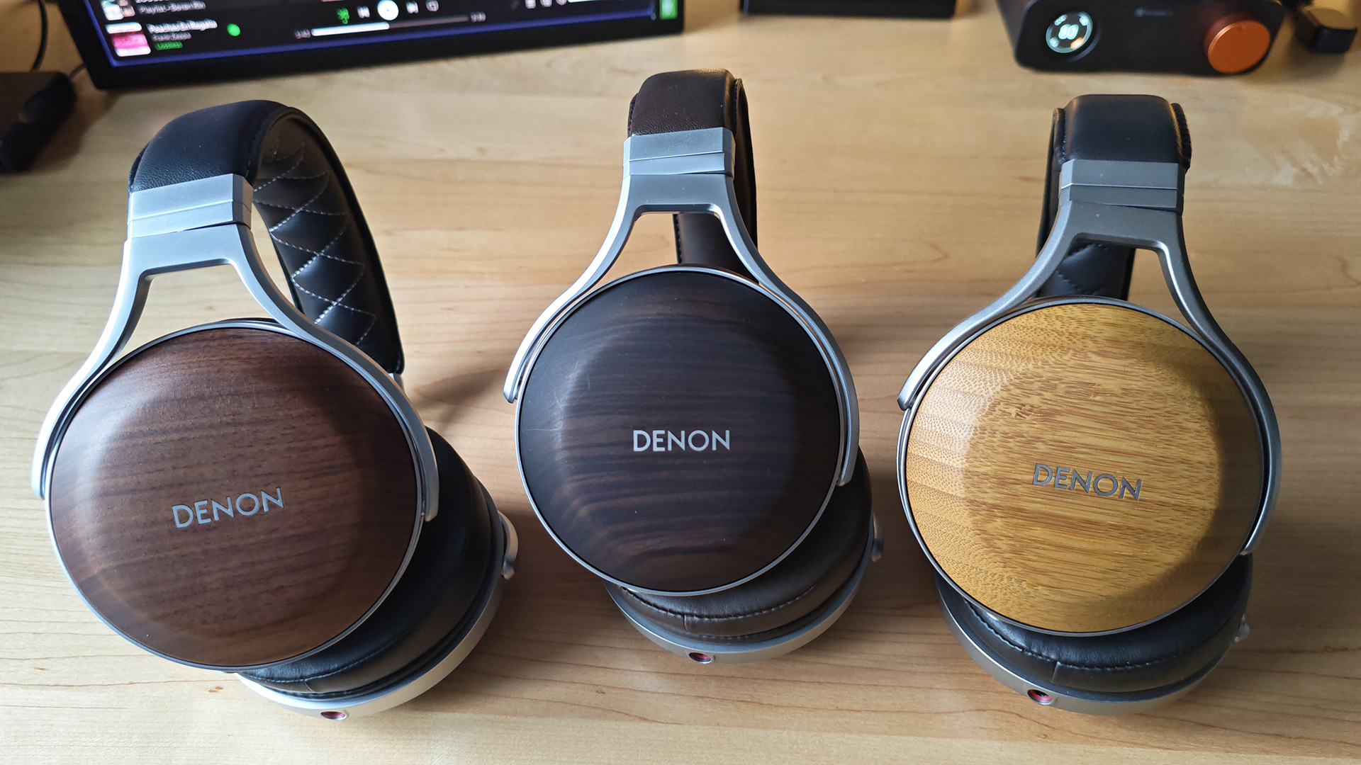 The Denon AH-D5200 and other headphones, photographed on a home desktop. 