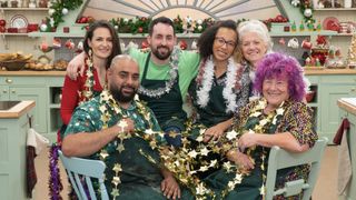 Sophie, George, Dan, Amelia, Linda and Carole in the tent wearing tinsel and stars in The Great British Bake Off.