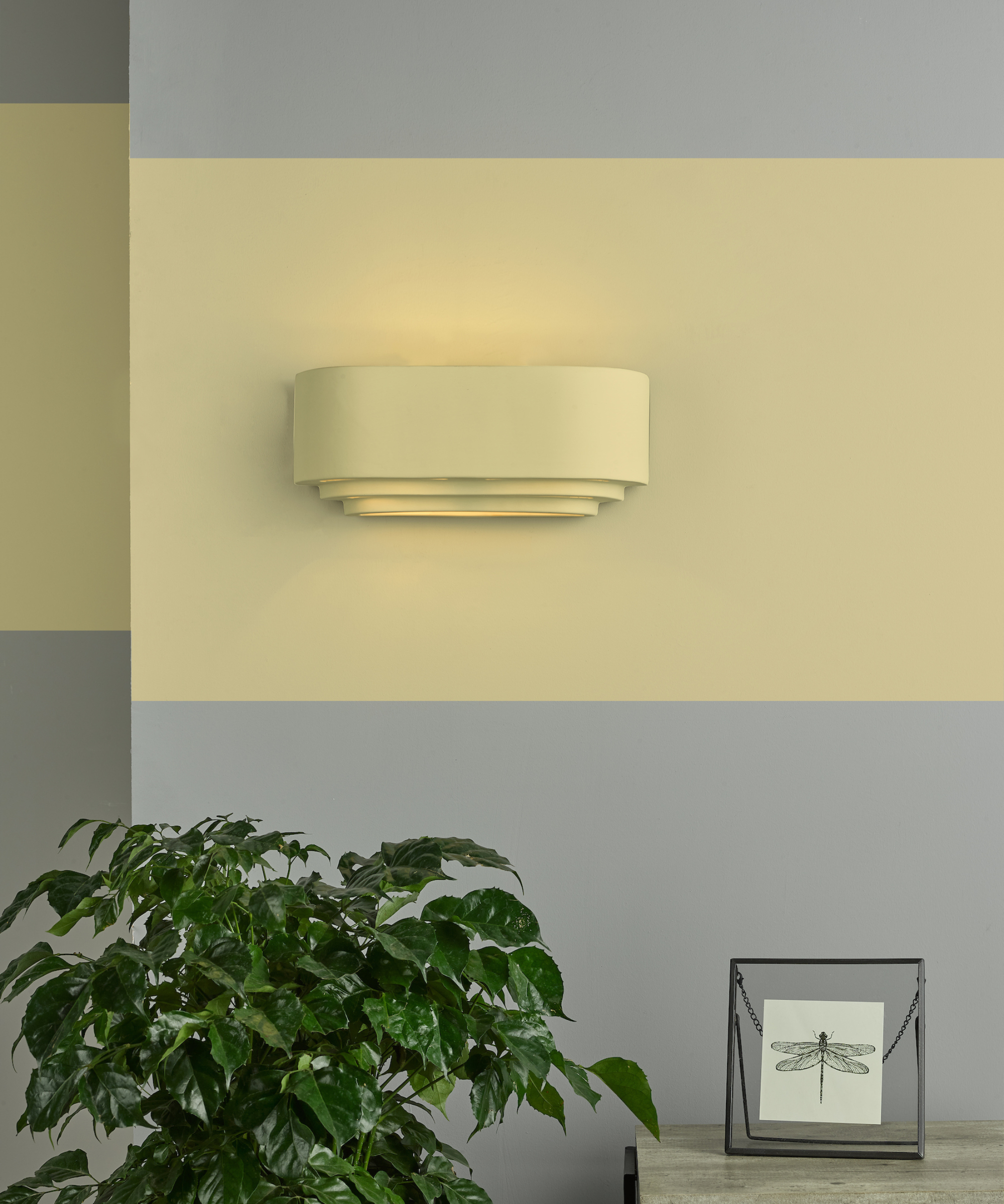 wall painted grey with yellow stripe running horizontally along wall and wall washer light painted in same shade of yellow