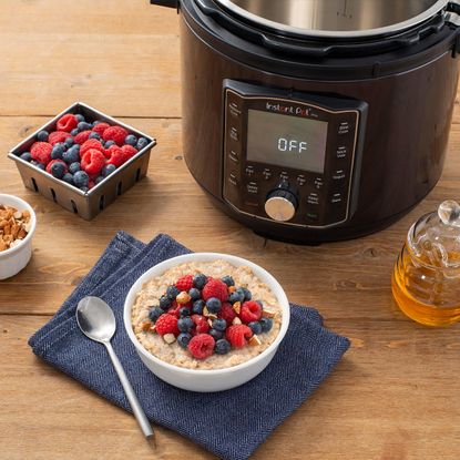 Instant Pot Pro on wooden counter top with porridge
