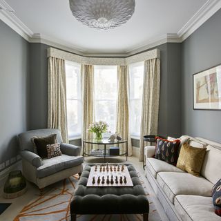 living room with grey wall and window with curtain