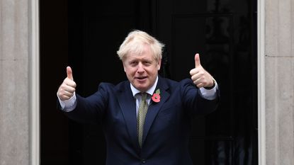 Boris Johnson gives a thumbs up outside 10 Downing Street.