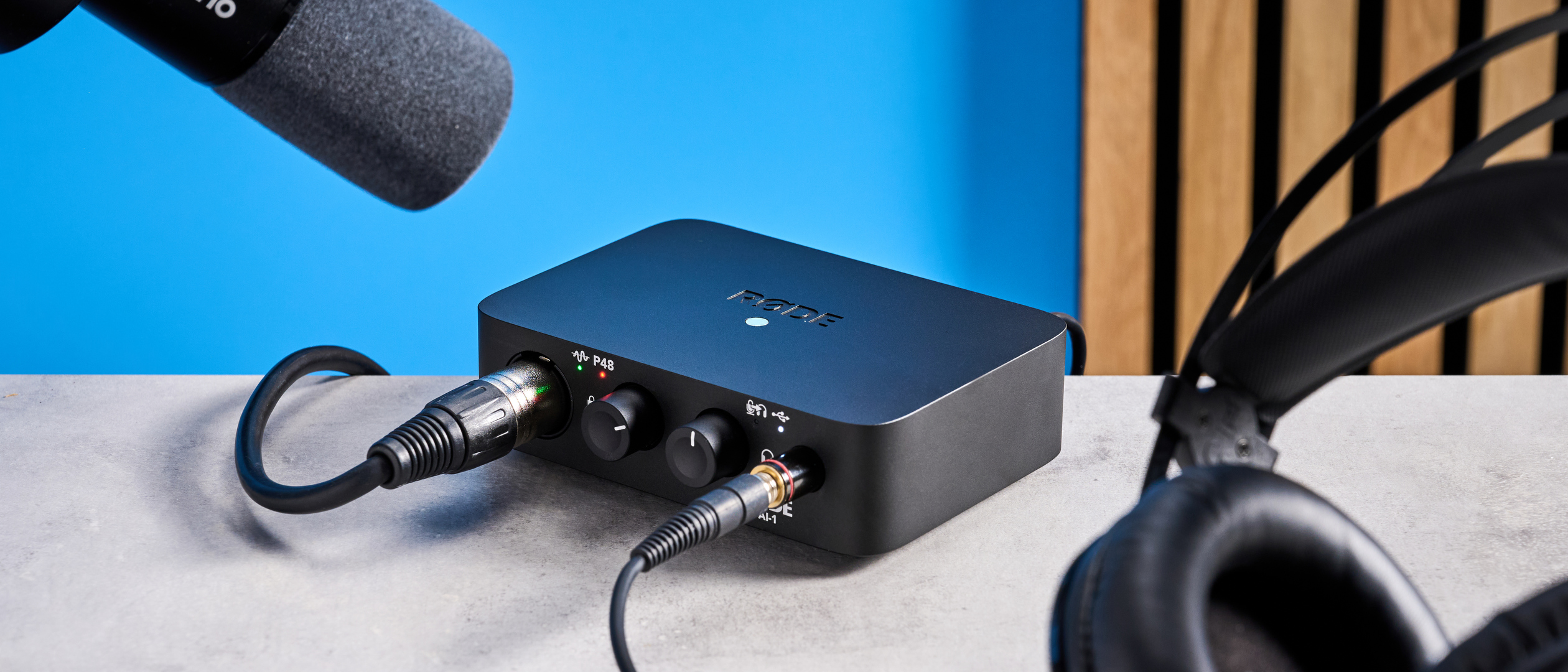 the rode ai-1 audio interface in black with an XLR input, a headphone input, and 2 speaker outputs