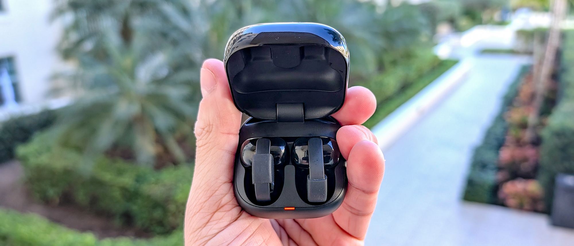 The Sony LinkBuds Clip in a Tom's Guide reviewer's hands and ears.