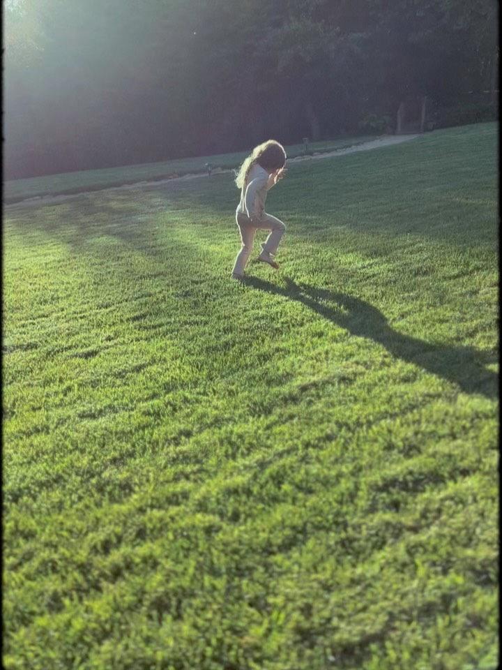 Princess Lilibet running through a field