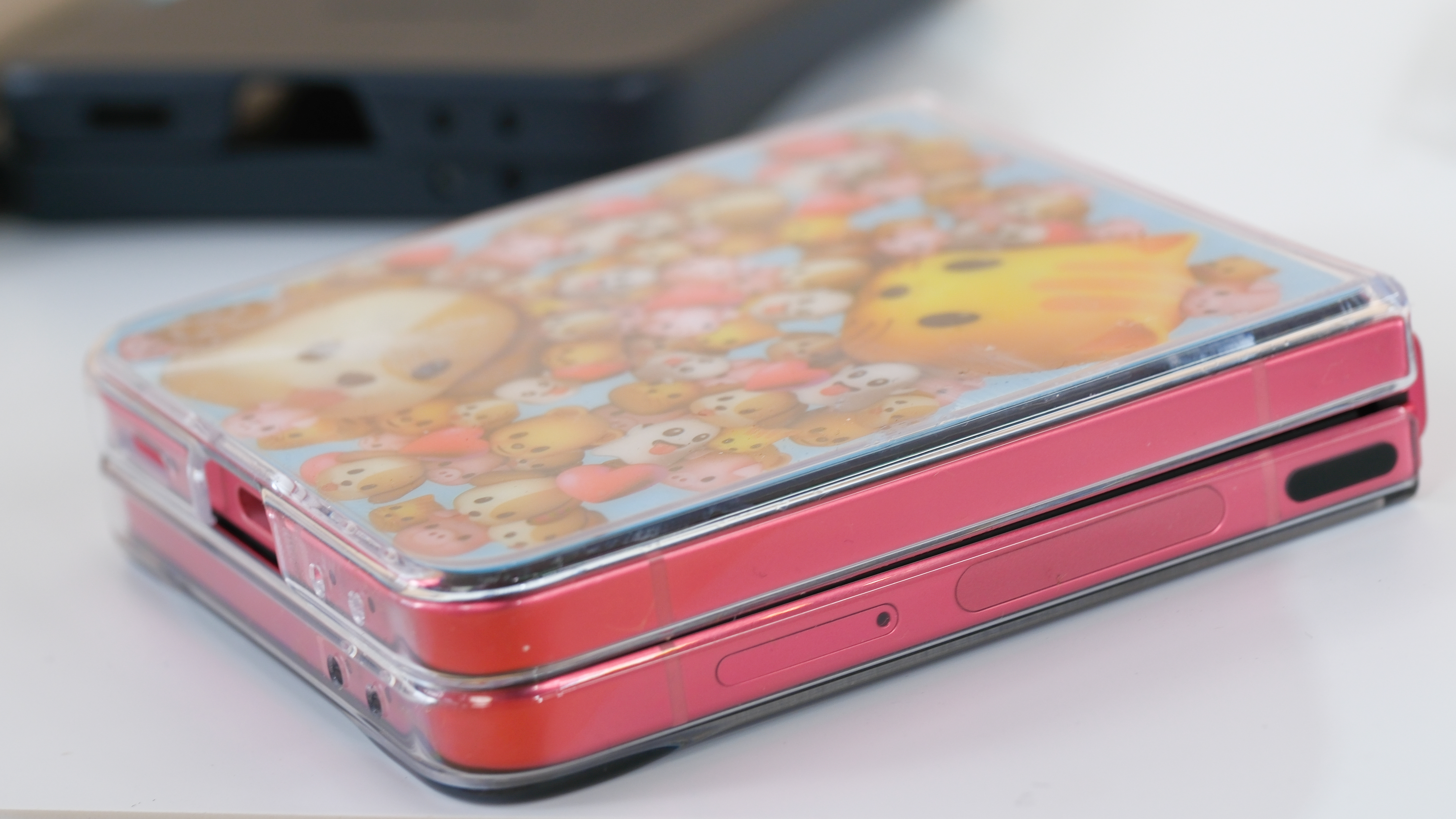 Samsung Galaxy Z Flip 7 in coralred from side closed in a cute case