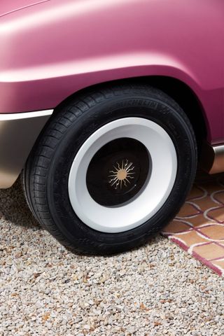 golden sun motif on car hubcap