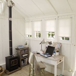 workspace with white wooden wall white flooring wooden desk and chair