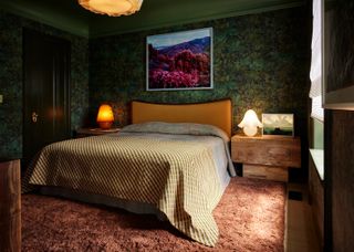 A green color drenched bedroom with a botanical wallpaper, a green ceiling, and a pink tufted rug