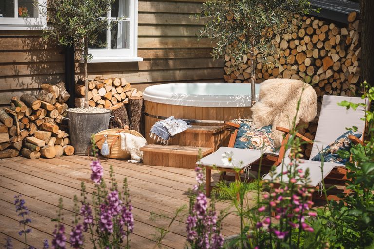 a rustic deck with a hot tub 