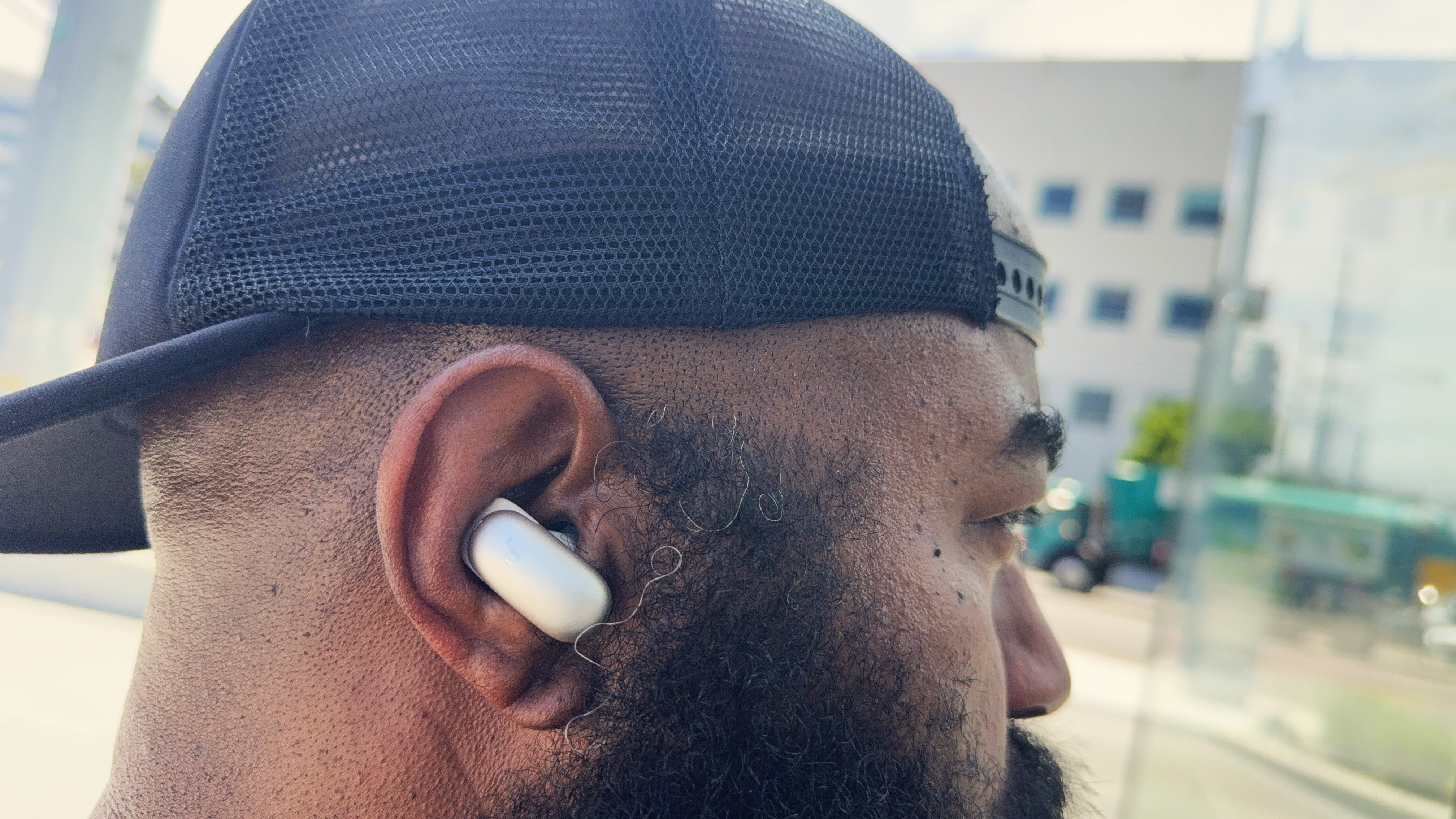 Reviewer wearing the Anker Soundcore Liberty 5 Pro Max on a busy metro street