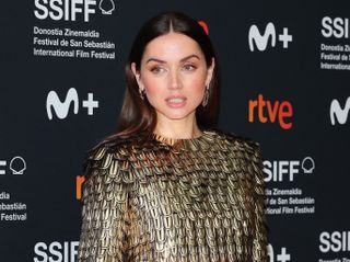 Ana de Armas on the red carpet wearing a gold top