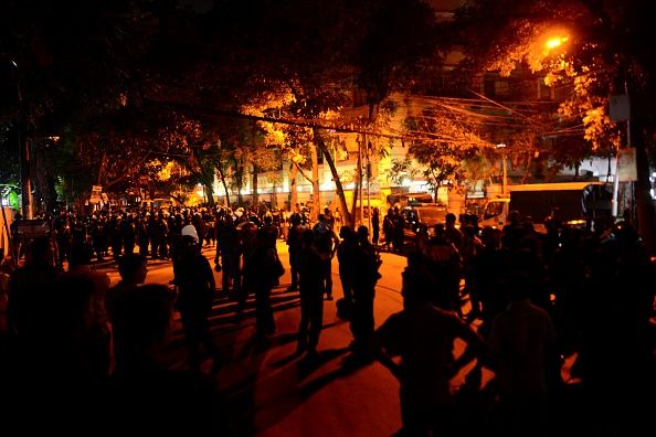 Police officers stand guard after attackers stormed a coffee shop in Dhaka on July 2.