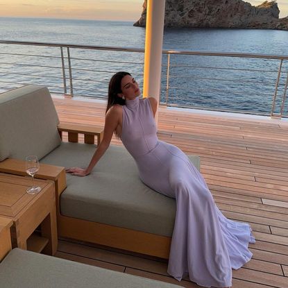 Kendall Jenner wears a semi sheer dress on a yacht in spain