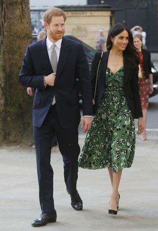 meghan markle wears a green floral dress and black blazer with pumps