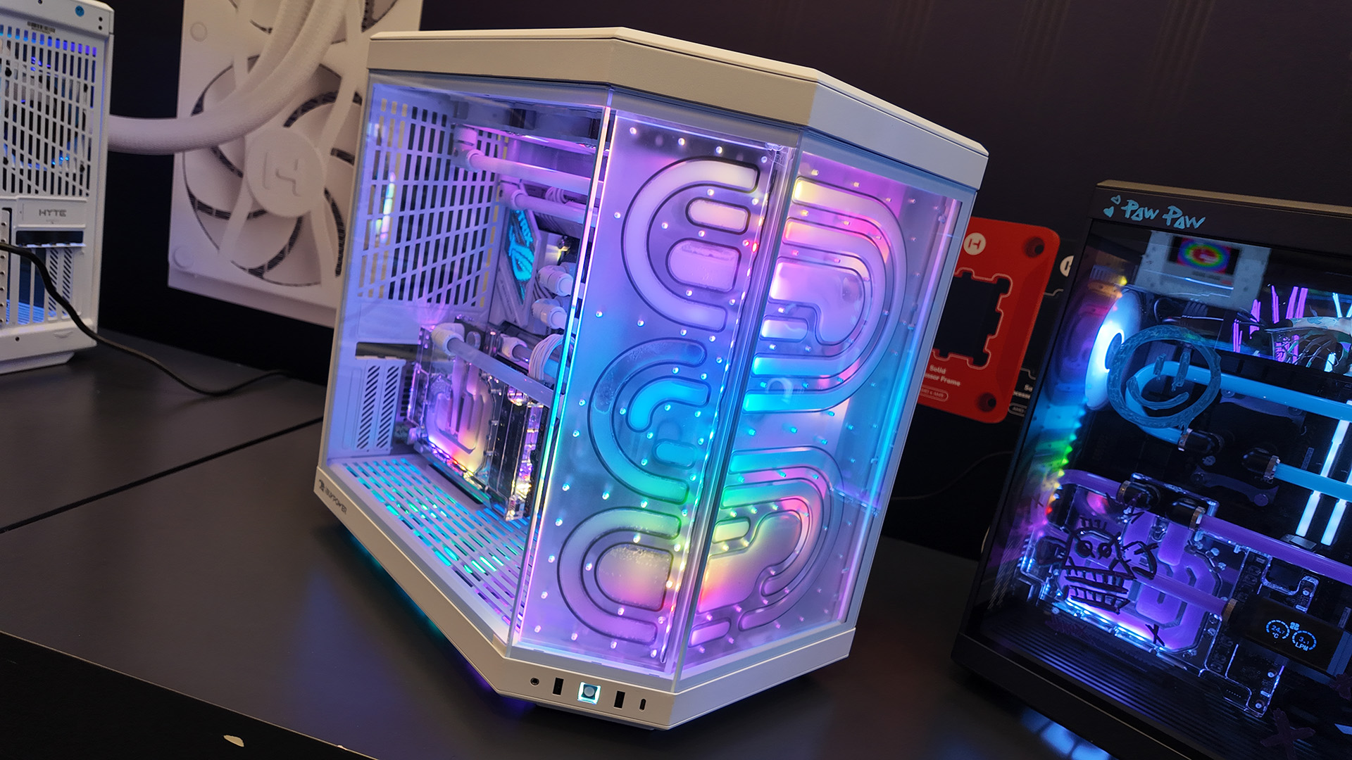 A gaming PC at the Hyte CES 2025 booth with a Bitspower distro plate and themed like Jinx from League of Legends.