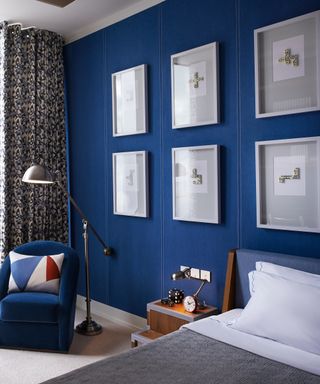 A series of pictures placed together on a blue wall in a bedroom