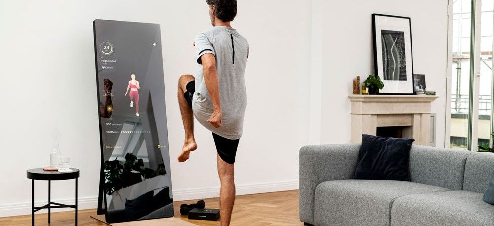 Man exercising in front of Vaha X fitness mirror