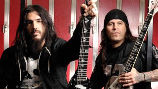 Machine Head’s Robb Flynn and Phil Demmell backstage at a gig, holding guitars