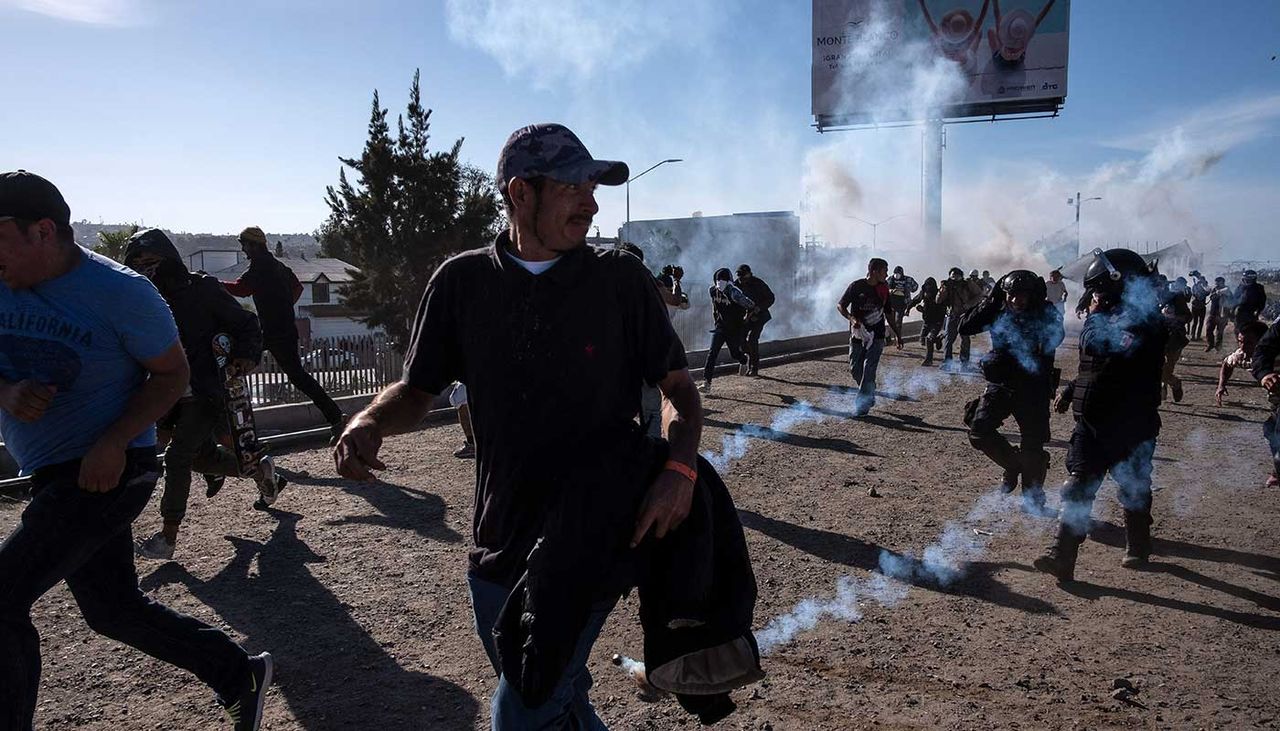 US Border and Customs fire tear gas as migrants storm the border crossing