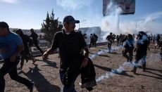 US Border and Customs fire tear gas as migrants storm the border crossing