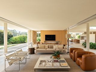 casa das palmeiras with its minimalist, low, white forms, curved openings and indoor/outdoor relationships in sao paulo's warm climate lifestyle