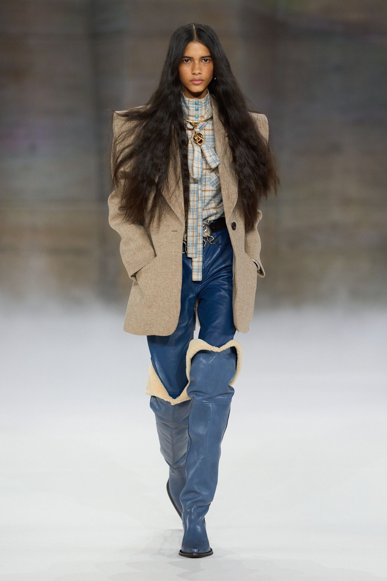 A model at the Chloé show wearing blue shoes.