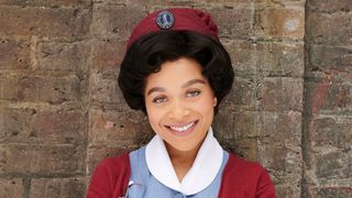 Leonie Elliot as Nurse Lucille Robinson wearing her nurses uniform and smiling at the camera