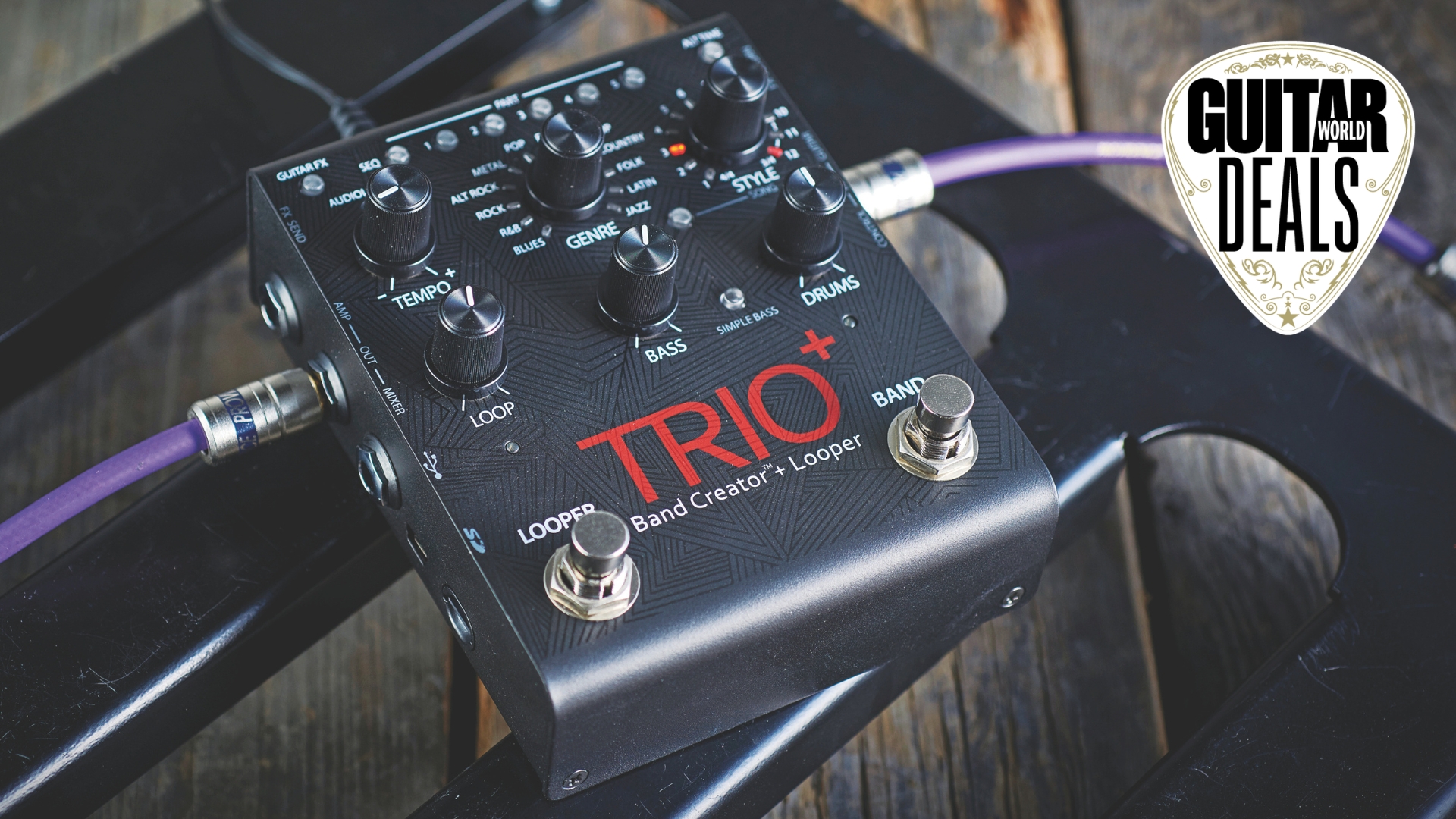 A Digitech Trio+ looper pedal on a pedalboard with purple guitar cables plugged into it