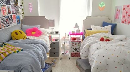 Dorm with two beds and colorful throw pillows