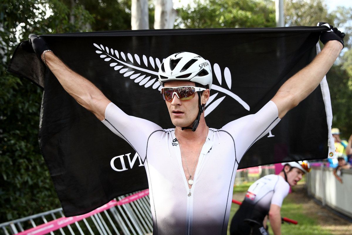 Sam Gaze with a New Zealand flag after winning gold