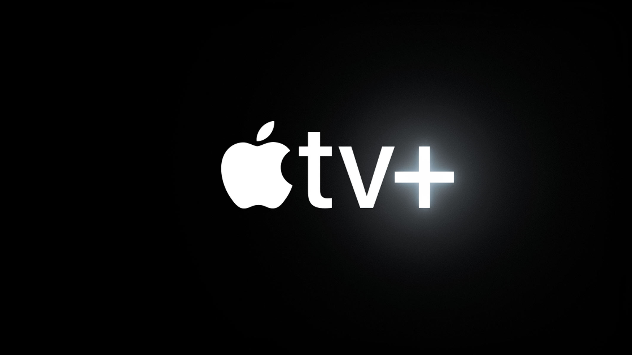 A white apple with a bite taken out of the right hand side is next to "TV +" all in white on a black background