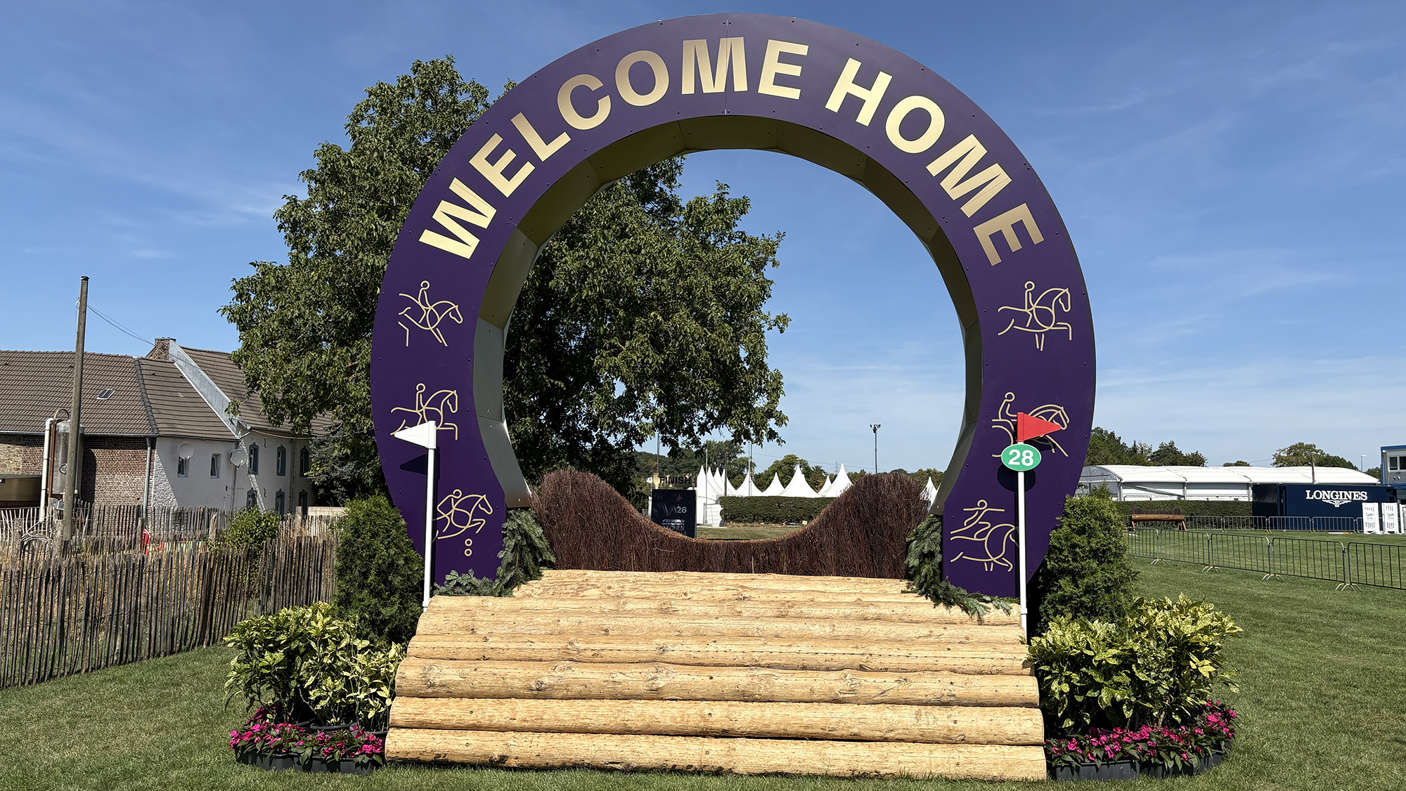 A fence decorated to say Welcome Home on the eventing World Championships cross-country course