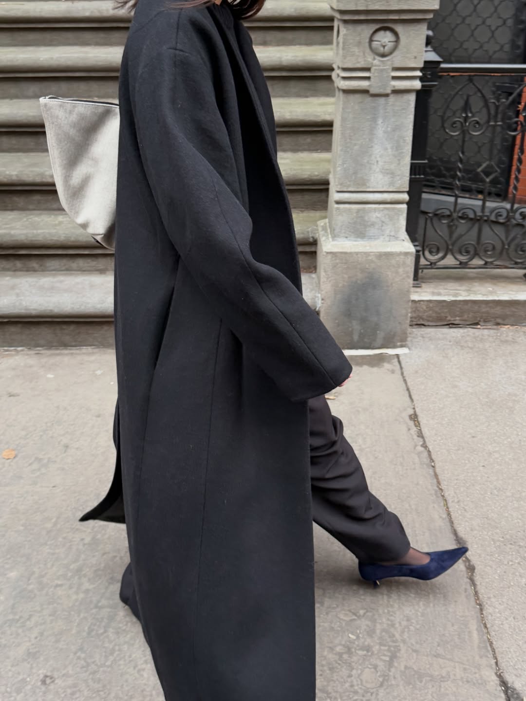 Influencer Mimi Nguyen wearing black trousers and navy heels.