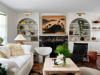 a living room with a white couch and arched built ins