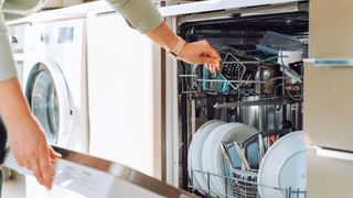 women taking out the dishwasher